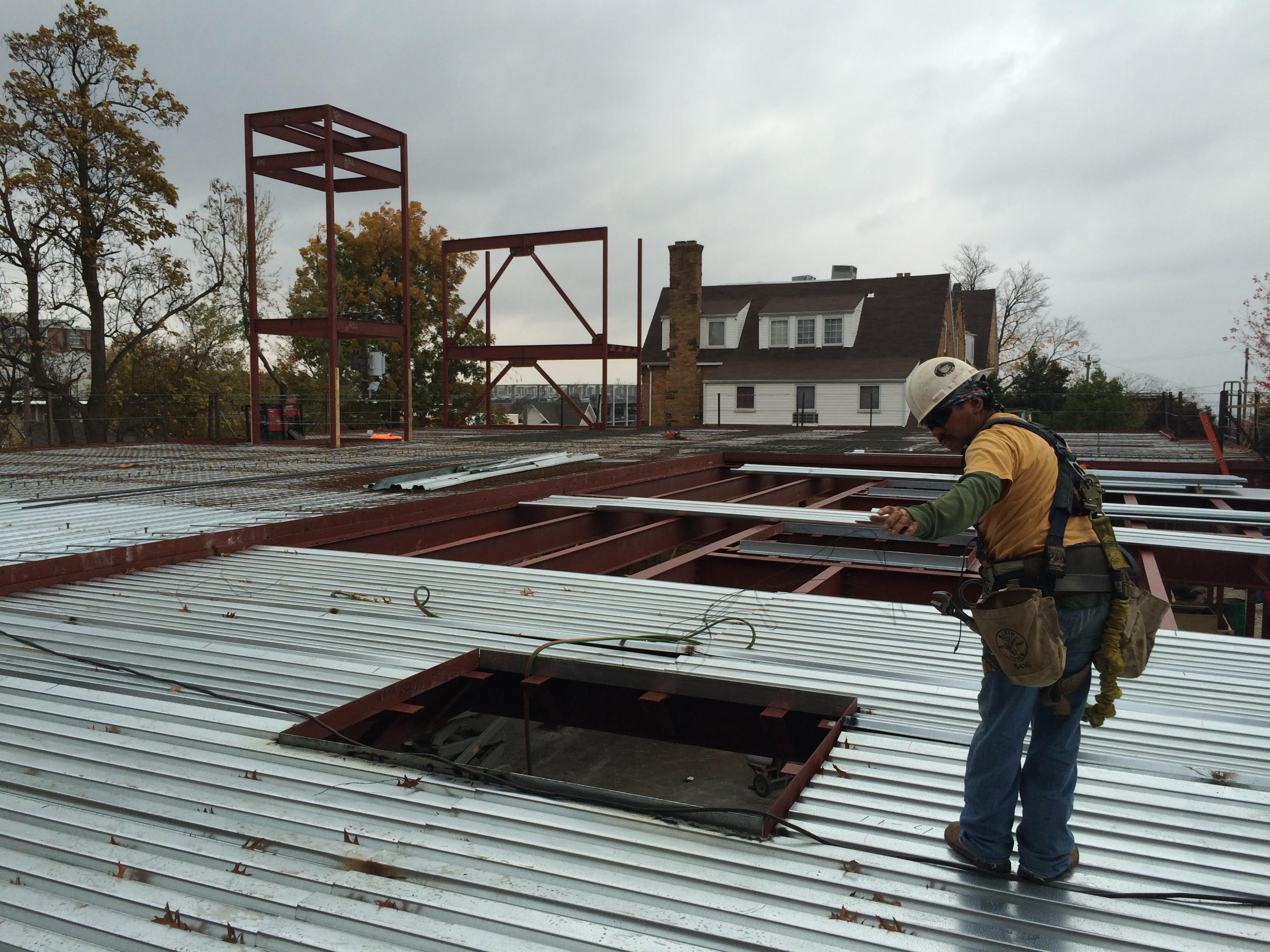 From 2nd floor bedroom looking east; showing formwork for Sundeck in foreground and 2nd floor in background. The elevator tower and north stair tower are steel framed in the distance. Once of the skylights / light monitors in the dining room below is in the foreground.